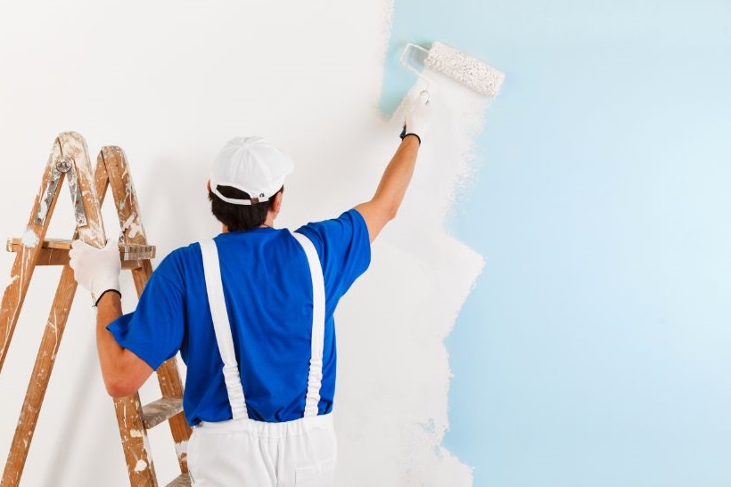 painter and decorator painting wall 